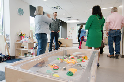 men and women standing in a classroom