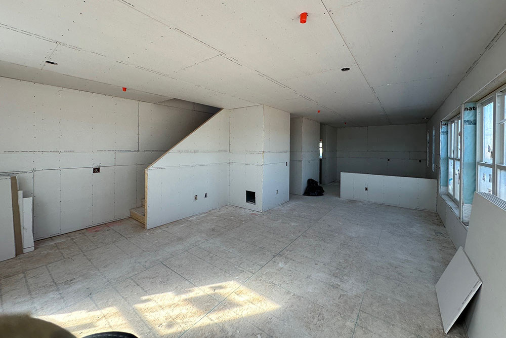 the interior of a home under construction with drywall hung