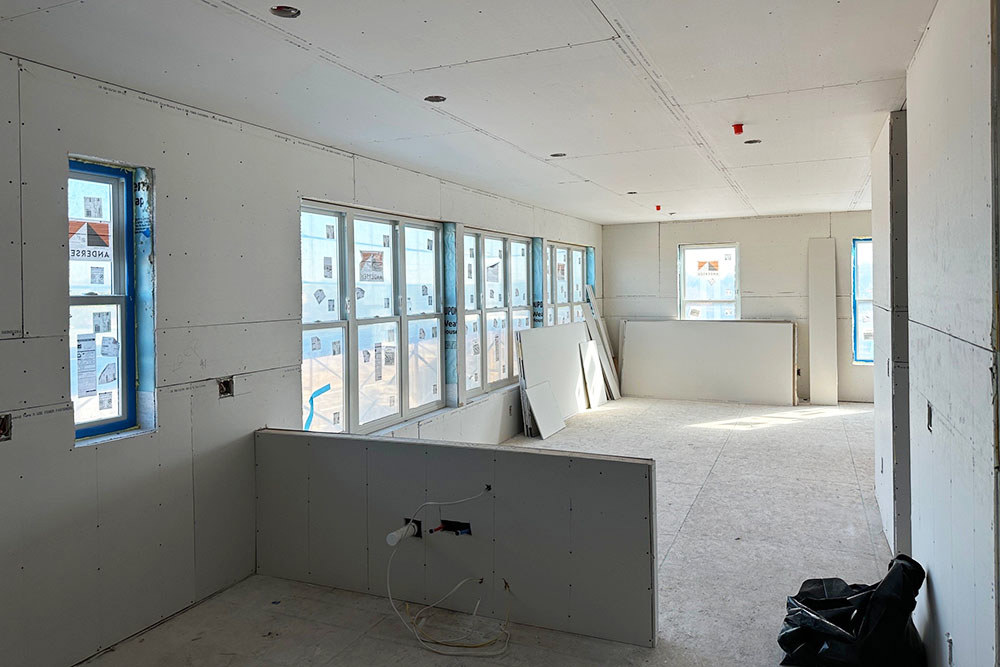 the interior of a home under construction with drywall hung