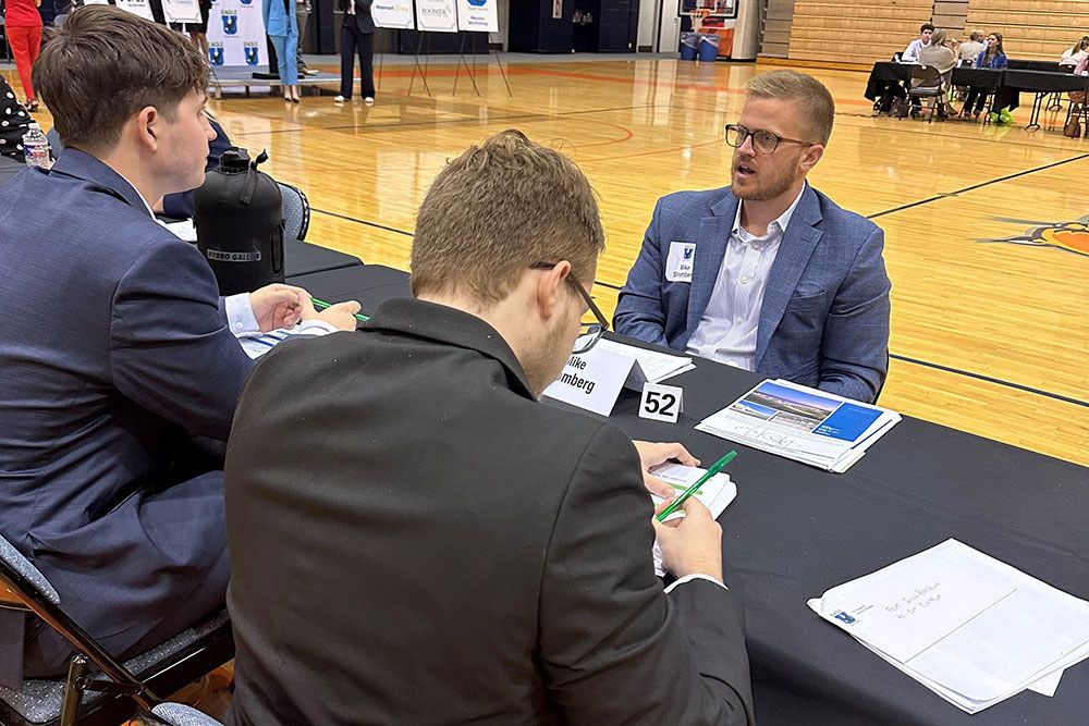 men in professional attire siting around a table