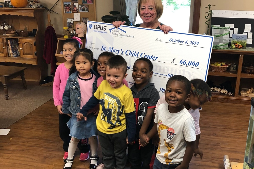 Children at St. Mary's Child Center smiling during the 2019 Opus Foundation's Building Community Award check presentation