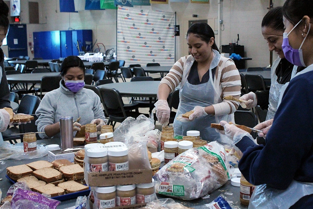 women making peanut butter sandwiches