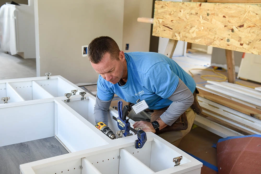 man building cabinet