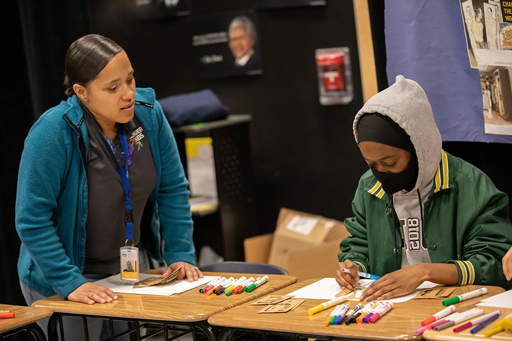 female teacher and male student in classroom at Denver Kids