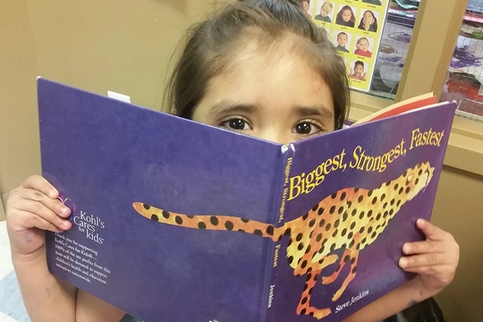 young girl reading book