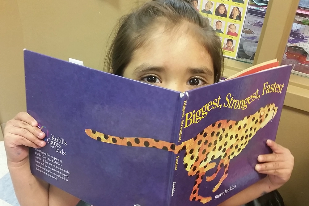 young girl reading book