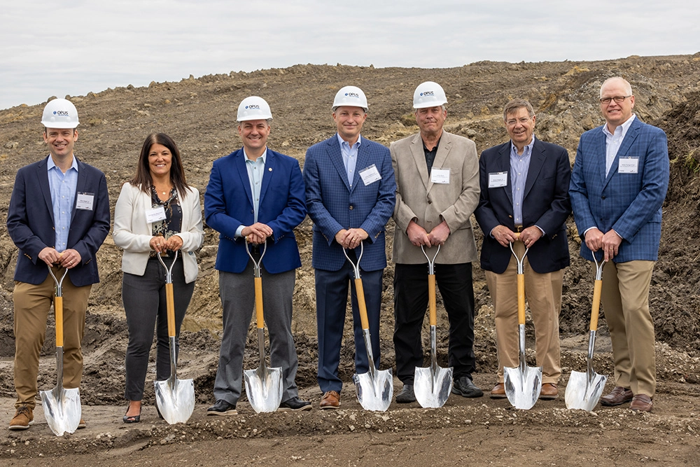 Group of men and women with helmets and shovels