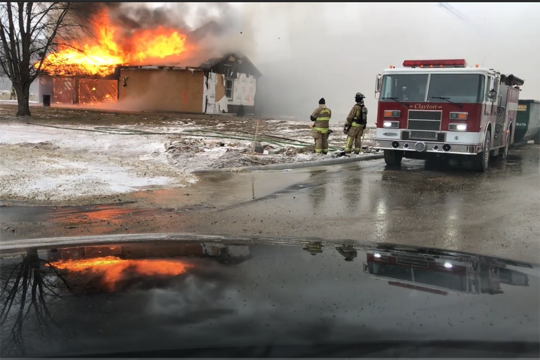 firetruck puts out burning building during firefighter training