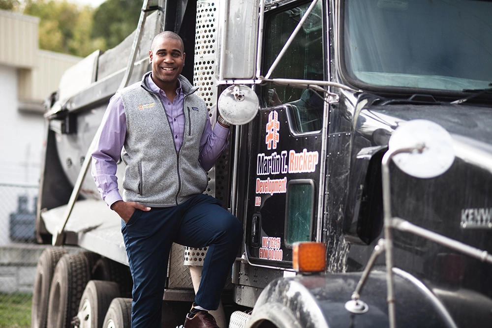 man standing beside semi-truck