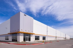 exterior of an industrial building with parking lot in foreground