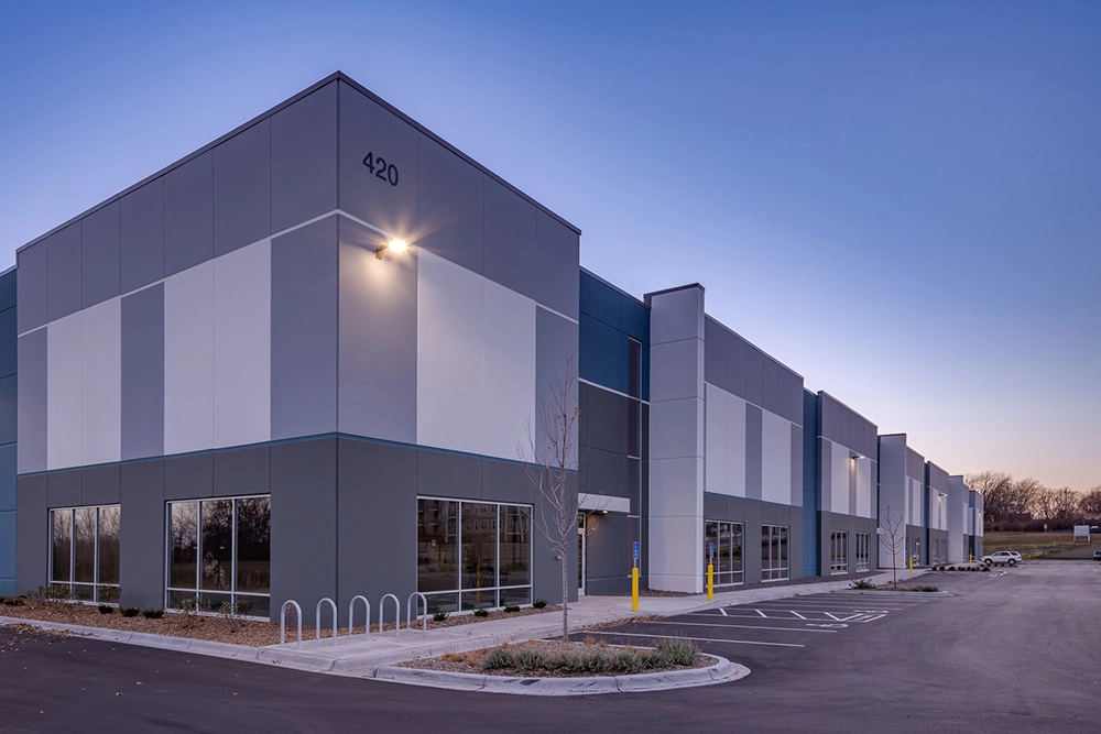 Front corner entrance of a speculative industrial building at dusk