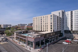 a large multistory apartment building with a pool deck