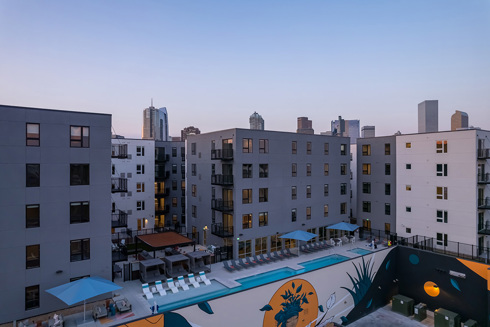 exterior of multifamily development with rooftop pool deck