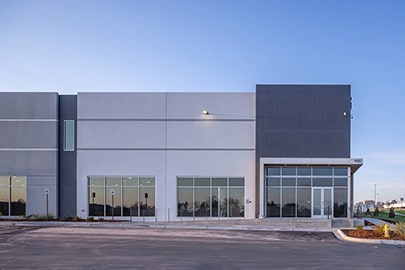 The entrance to an industrial building at dusk.